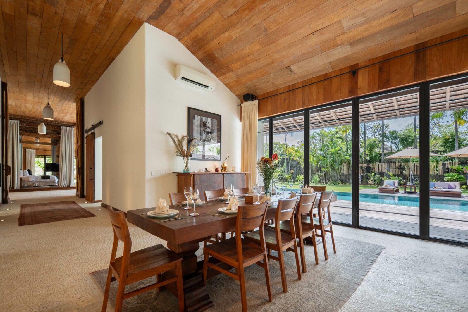 The dining table with the pool beyond the glass