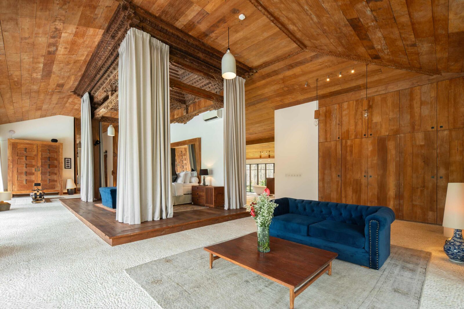 The bed platform in the master suite, framed by blackout curtains