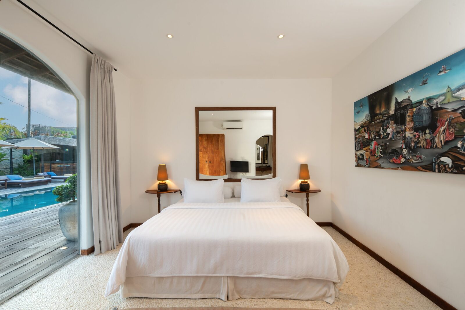 The pool-view bedroom, its glass doors opening straight onto the pool
