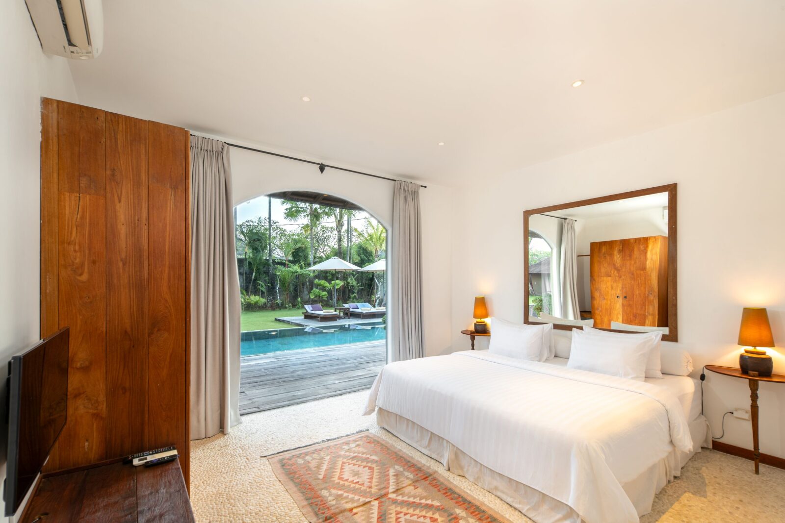 The pool-view bedroom, looking out to the water