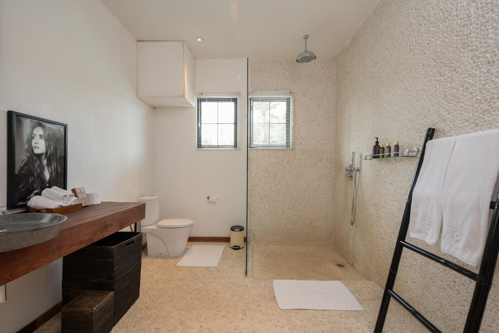 The rain shower in the pool-view bedroom's private bathroom