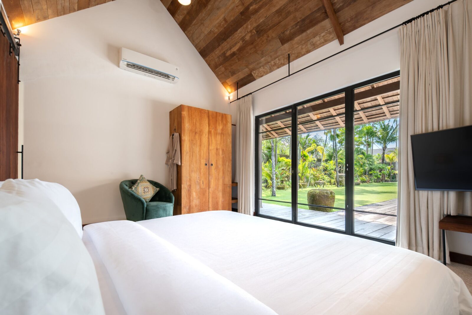 A pool house bedroom opening onto the garden